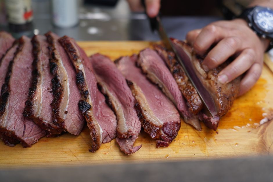 Sliced smoked brisket on a cutting board
